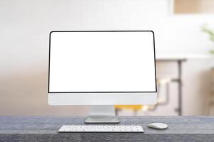 Computer monitor with wireless mouse and keyboard over blurred vintage office as background. photo