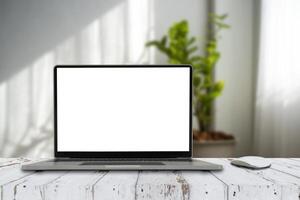 Empty space,Wooden Computer Desk and Laptop with blank screen photo