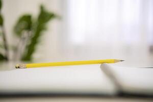 Notepad and pencil on the table photo
