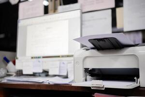 White printer in office with soft-focus and over light in the background. photo