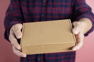 delivery man carrying cardboard parcel with label with copy space. photo