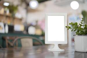 Mock up menu frame on table with restaurant cafe shop photo
