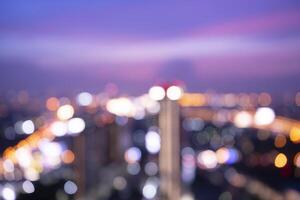 Blurred view of city traffic lights at night photo
