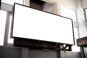 Mock up blank perspective horizontal billboard with clipping path on the wall near entrance in building photo