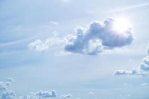 Sun in blue sky with cloud and the bright sun with rays and highlights photo
