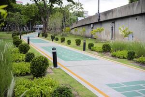 Running track with shade under the trees in public park in summer photo