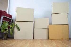 Moving boxes with belongings in empty room photo