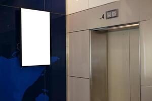 Blank vertical billboard or poster in the elevator hall. photo