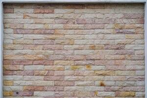 Wide beige brick wall background texture. Home and office design backdrop photo