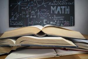 stack of books on the blackboard background photo