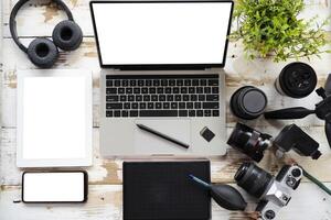 desktop with photography equipment, camera, tripod,flash and computer photo