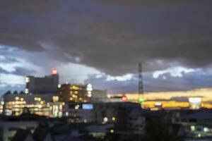 Abstract blur aerial view city on twilight color sky and clouds cityscape autumn sunrise background. photo