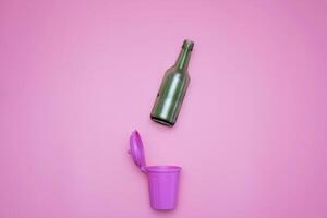 top view of trash bins and assorted garbage isolated on pink, recycle concept photo
