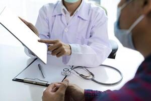 Woman doctor using tablet computer while. Doctor consultation with the patient by using digital tablet photo