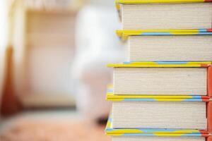 Book stack in the library room and blurred bookshelf for business and education background photo