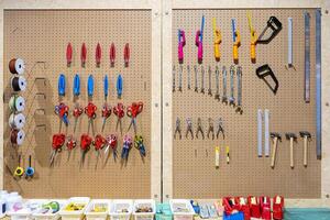 Workshop scene. Tools on the table and board. Glue, tape measure, steel ruler, screwdriver photo