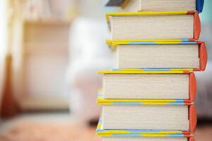 Book stack in the library room and blurred bookshelf for business and education background photo