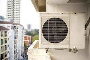 Closeup of air conditioner compressor outside building. photo