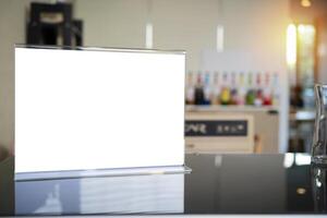 Stand mock up menu frame standing on wood table in bar restaurant cafe. space for text. photo