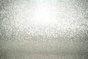 Silver Sparkling Lights Festive background with texture. Abstract Christmas twinkled bright bokeh defocused and Falling stars. Winter Card or invitation photo