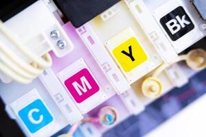 Printer in cartridges.select focus. ink tank for refill, CMYK ink tank installed on the side of inkjet printer photo