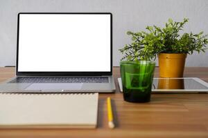 Conceptual workspace, Laptop computer, Notebook, tablet with blank white screen on table photo