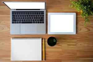 Conceptual workspace, Laptop computer, Notebook, tablet with blank white screen on table, Top view photo