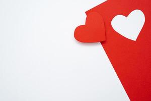 A red card cut into a heart shape, communicating on Valentine's Day. photo