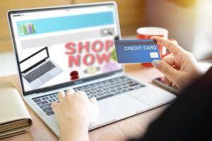 Online Shopping Website on Laptop. Easy E-commerce Website Shop by Smartphone, iPhone, iPad and Laptop. Close up Hands Using Smartphone Shopping Cart read Online Article, Blog. Digital Payment gateway photo