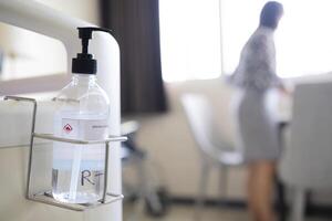 The alcohol gel washes hands that were installed. In a recovery room at the hospital photo
