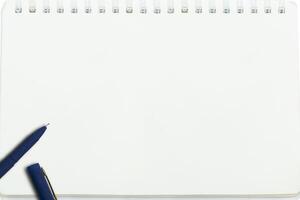 Empty notebook paper for text with blue pen photo