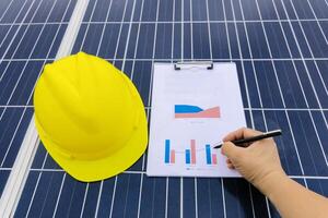 Engineer working on checking and maintenance equipment at industry solar power photo