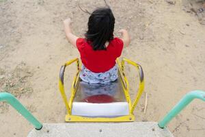 Asian girl playing wooden slider and happy fun or cheerful enjoy During the lunch break at school photo