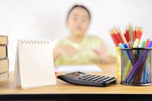 The next scene is a pencil box, calculator, blank notebook to put text photo