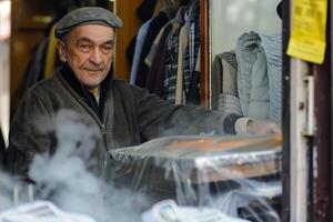 Senior man working at a clothing store photo