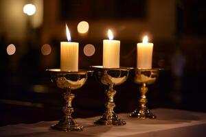 Three candles burning in ornate holders with a soft, warm glow photo