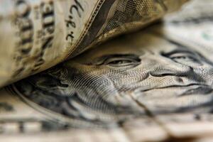 Close up view of benjamin franklin on us 100 dollar bill photo