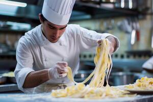 Professional chef preparing fresh pasta in kitchen photo