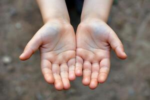 Closeup of open, empty hands extended forward, symbolizing giving, receiving, or assistance photo