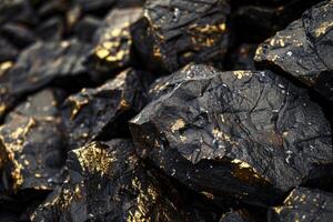 Black and gold painted rocks forming an abstract background texture photo