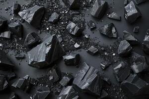 Black tourmaline scattered on dark background creating abstract pattern photo