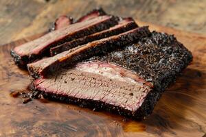 Smoked beef brisket sliced on wooden cutting board photo