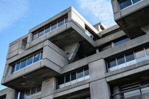 Brutalist architecture building facade with concrete geometric shapes photo