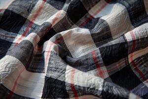 Black white and red fabric with check pattern lying in folds photo