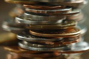 Stack of international coins creating high rise shape photo
