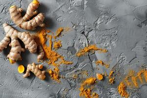 Fresh turmeric roots on textured background photo