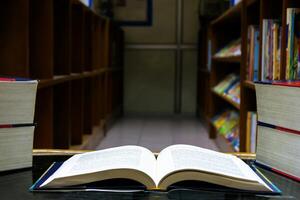 The open book was placed on a table in the library photo