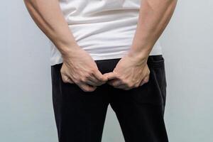 Man hand holding her bottom because having Abdominal pain photo