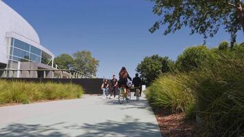 Google employees riding a Google bike and working on campus. Day life inside Google campus in Mountain View. video