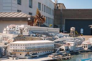 Detailed scale model of Alcatraz prison in San Francisco, USA. Model captures rugged terrain, prison complex, guard tower, and surrounding buildings with meticulous detail. photo